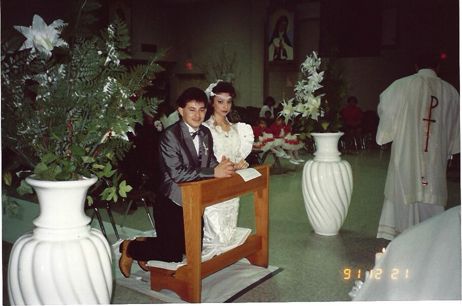 Ramon and Gracie kneeling together at their wedding ceremony, December 21, 1991.