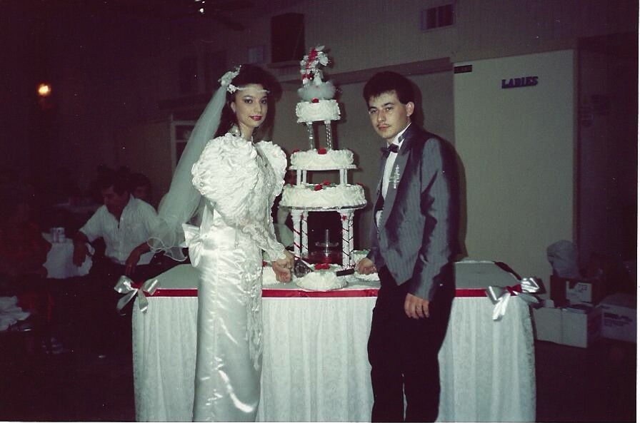 Ramon and Gracie cutting the cake at their wedding reception.